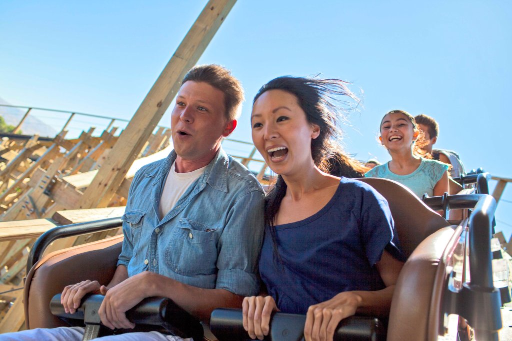 People enjoying a thrilling roller coaster ride, laughing and smiling in Santa Clara, California.