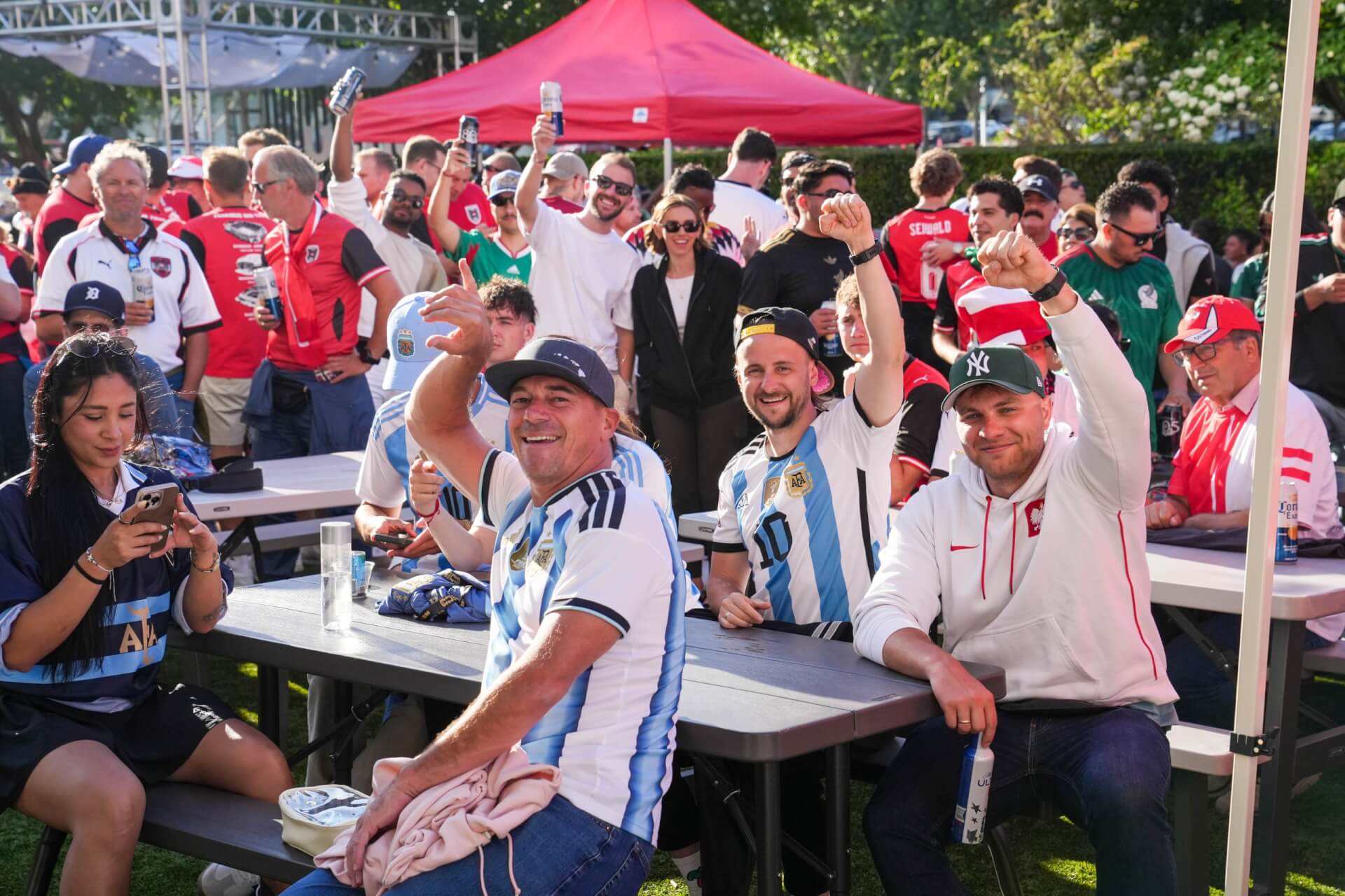 Best 49ers Game Day Hotel Activations in Santa Clara A group of soccer fans celebrating at an outdoor event with drinks in Santa Clara, California.