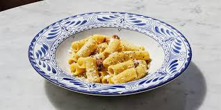 A bowl of pasta with a decorative plate, featuring a blue and white pattern in Santa Clara, California.