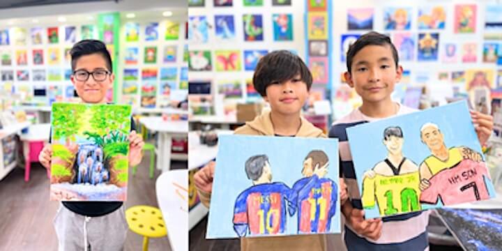 Three young boys proudly display their colorful paintings of landscapes and soccer players in an art studio in Santa Clara, California.