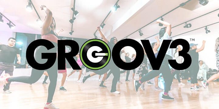 A diverse group of people dancing energetically in a modern studio with the Groov3 logo prominently displayed in Santa Clara, California.
