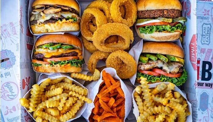 iniBurger Santa Clara A variety of burgers, onion rings, and fries in a fast-food meal box in Santa Clara, California.