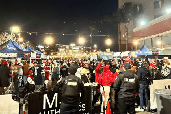 World Cup Takeover @ The End Zone A bustling night market with numerous tents and crowds of shoppers under bright lights in Santa Clara, California.