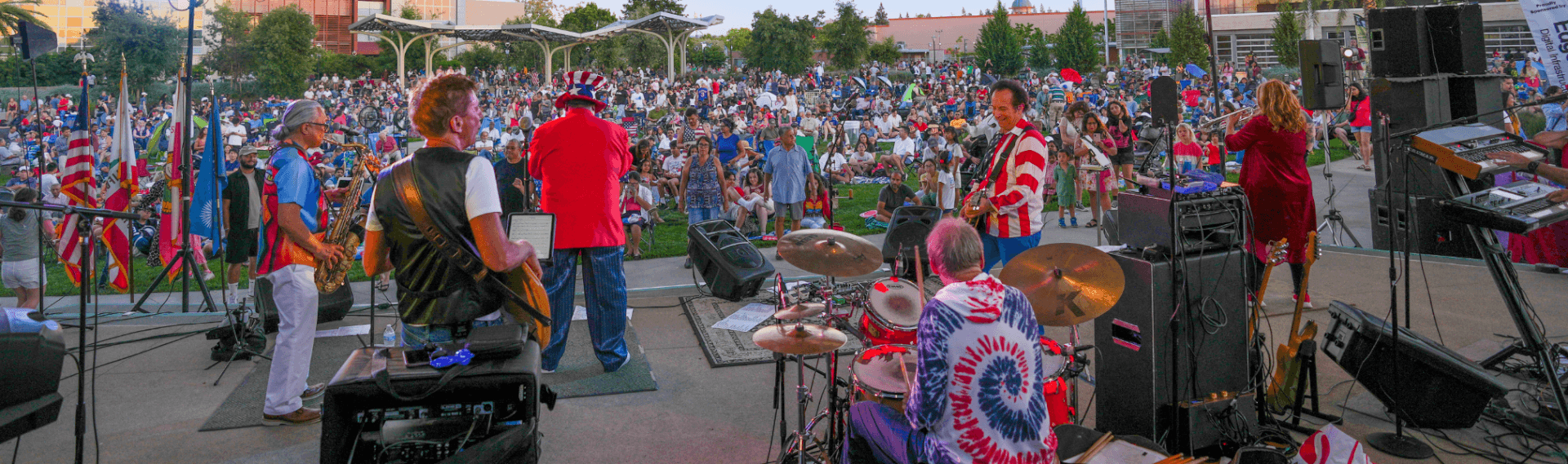 Fourth of July in Santa Clara Events, Fireworks, and More for 2026 A vibrant outdoor concert with a large crowd enjoying live music in a park setting in Santa Clara, California.