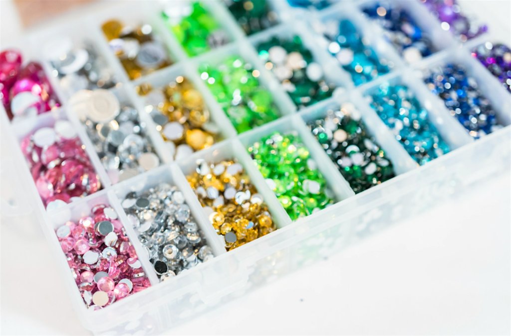 A plastic organizer box filled with colorful rhinestones in various shades in Santa Clara, California.