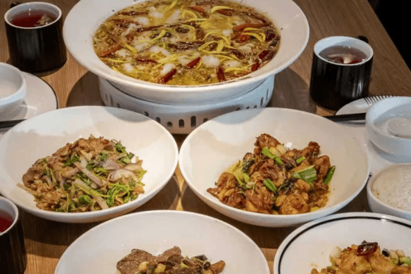 TAI ER SICHUAN CUISINE 太二川菜 (Valley Fair) A table spread with various Chinese dishes including fish soup and stir-fried meats in Santa Clara, California.