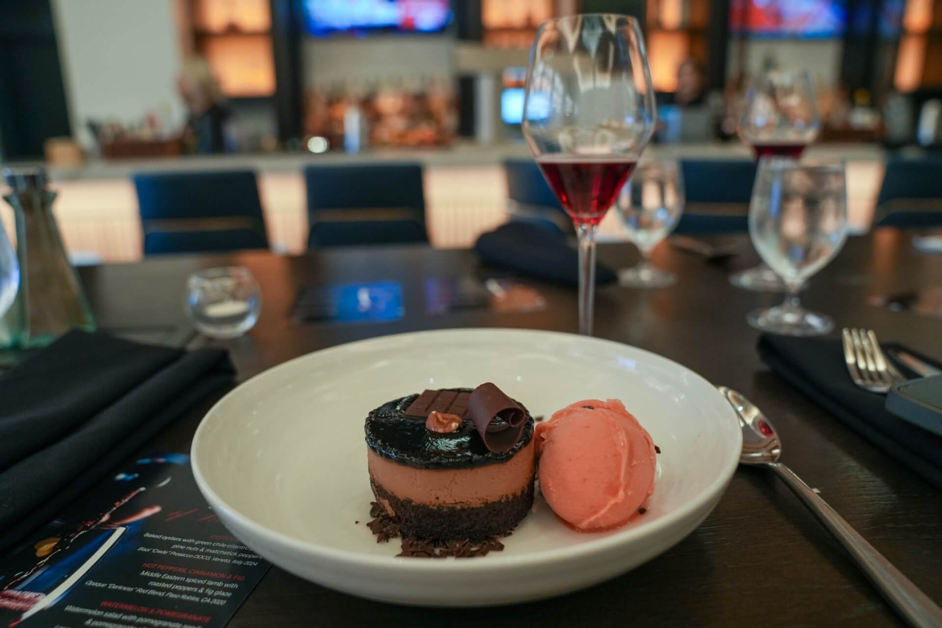 October Events in Santa Clara 2026 A chocolate mousse dessert served with a scoop of pink sorbet on a plate in Santa Clara, California.
