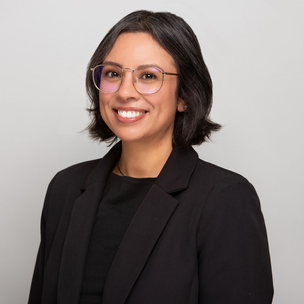 Sporting Events A smiling woman with dark hair and glasses wearing a black blazer in Santa Clara, California.